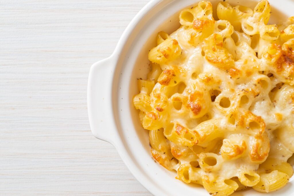 Macaroni and cheese in a white bowl.