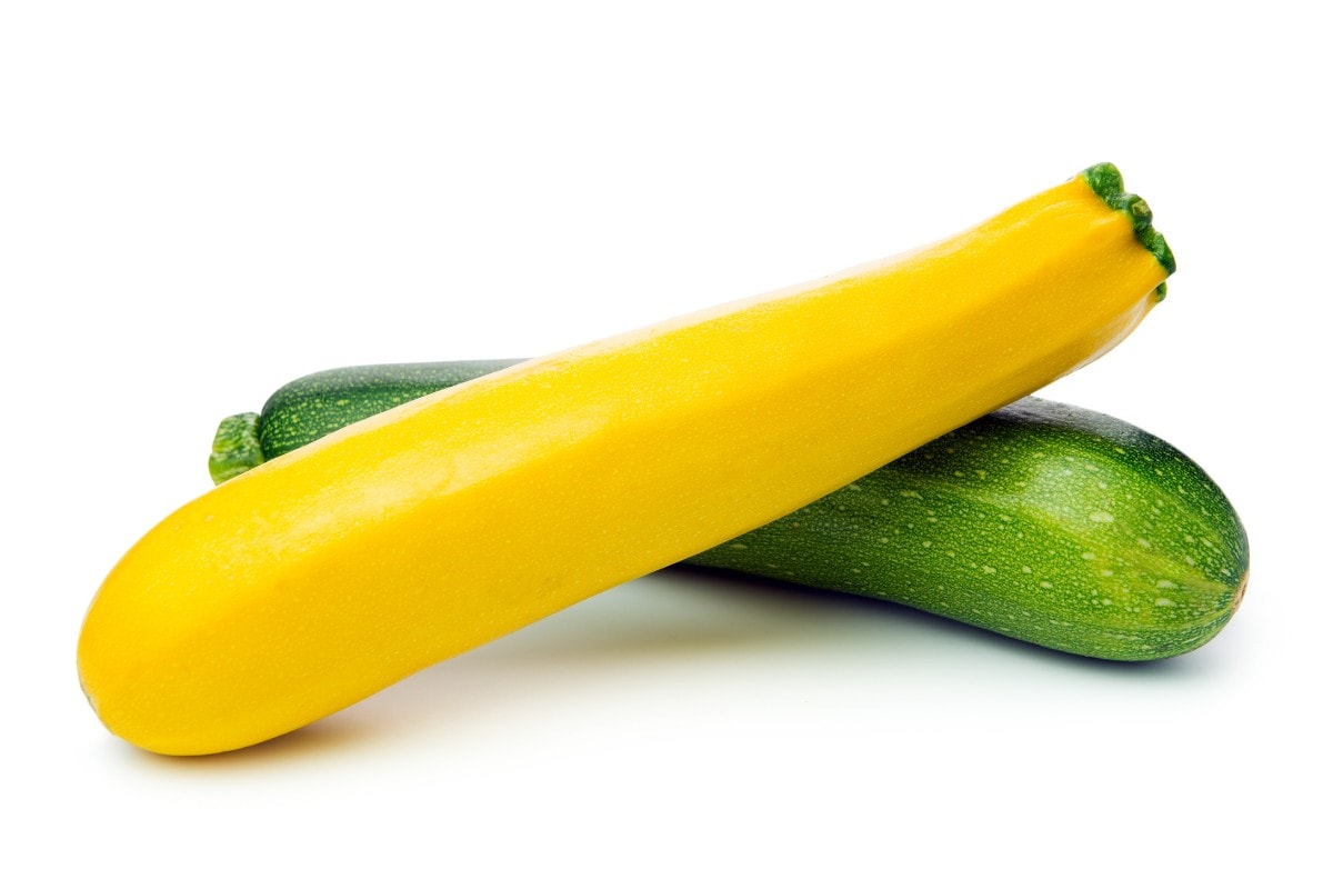 A yellow zucchini and a green zucchini on a white background.