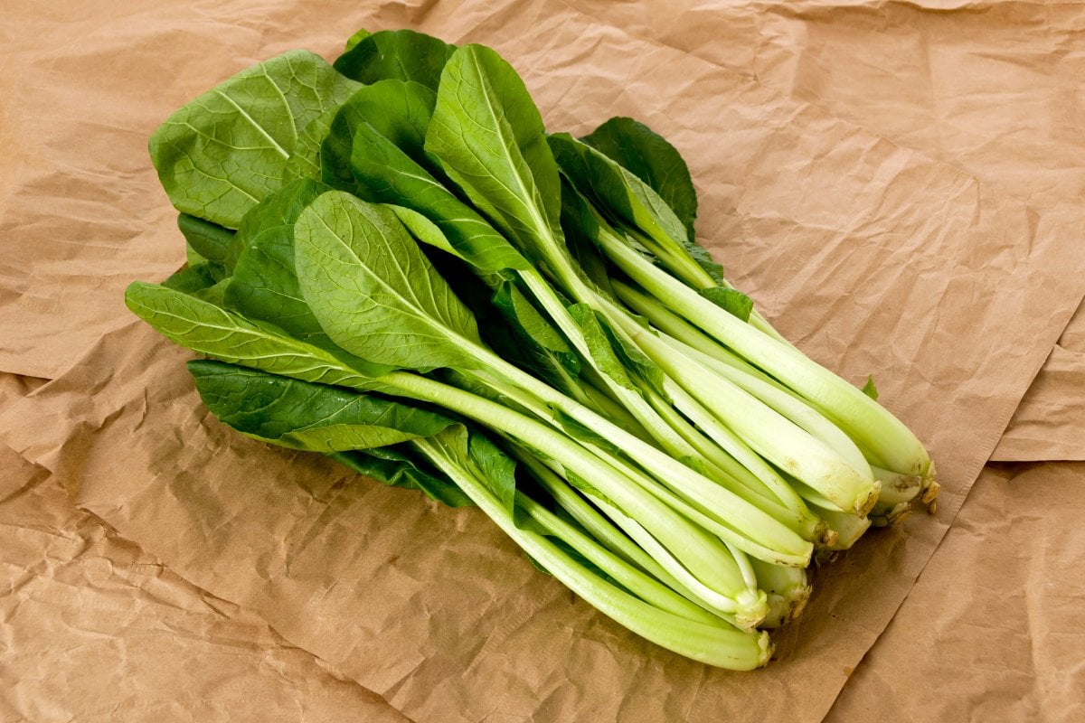Bok choy on brown paper.