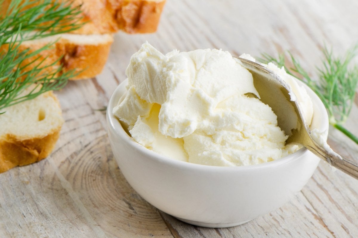 A small white bowl filled with cream cheese.