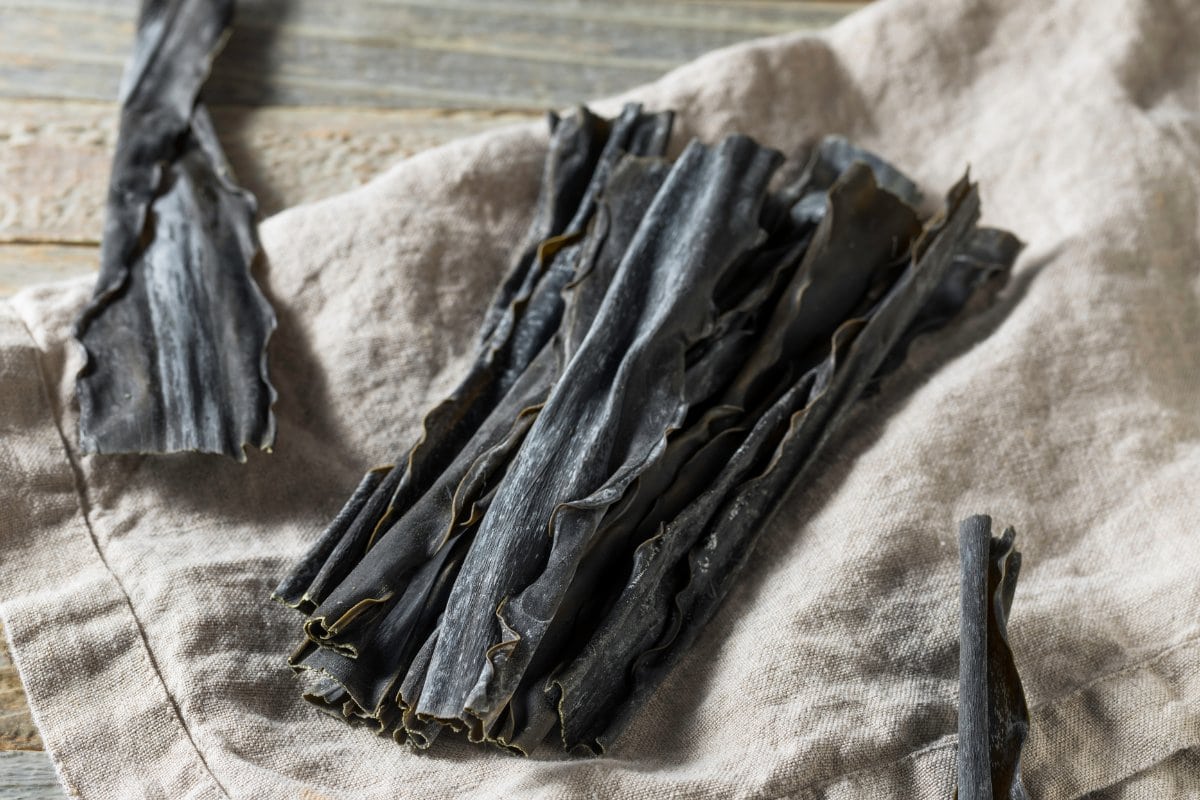 A bunch of black seaweed on a cloth.