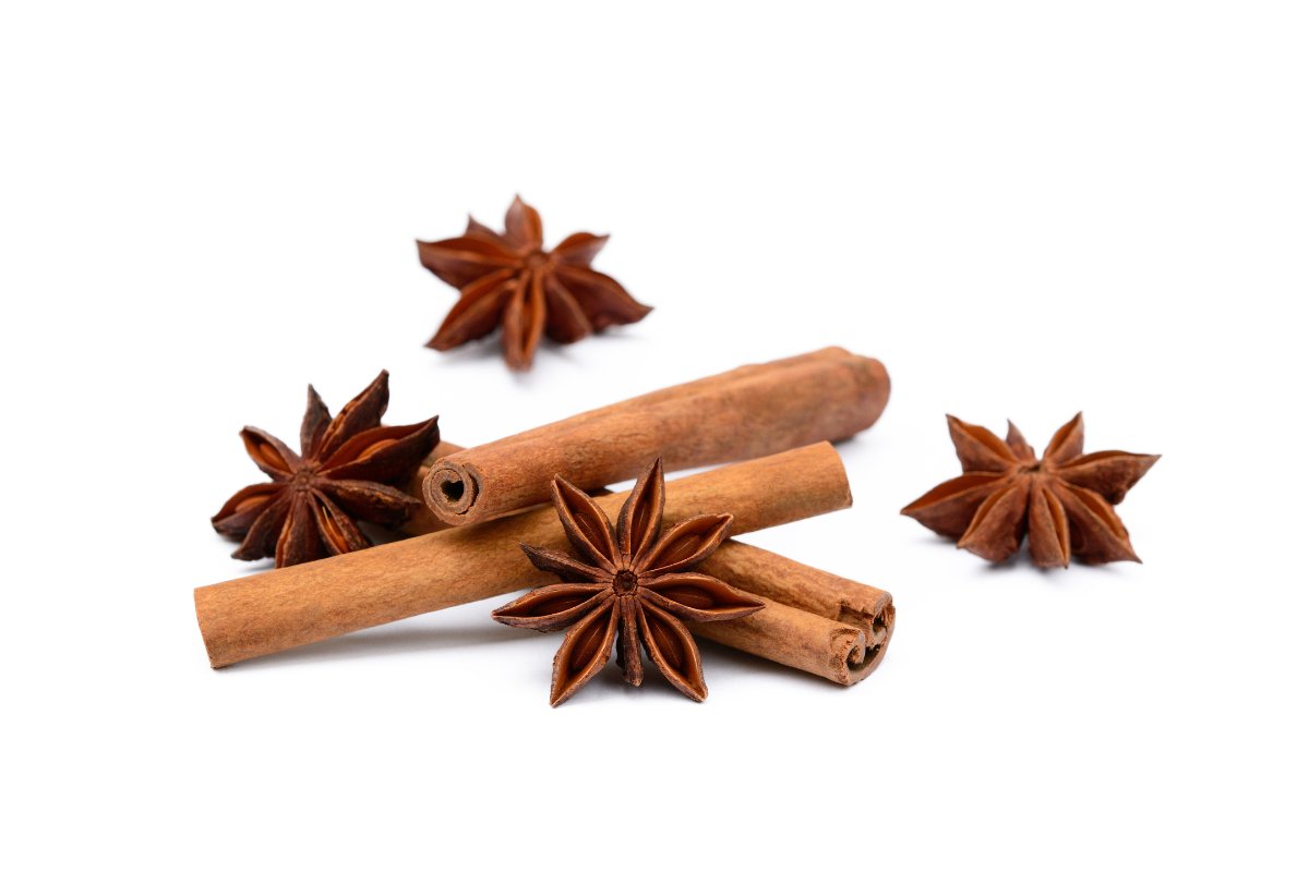 Cinnamon sticks and star anise on a white background.