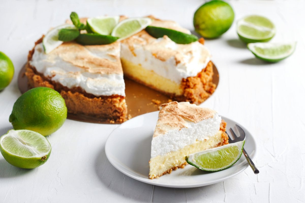 A slice of lime meringue pie on a plate.