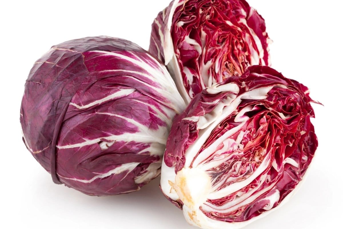 Three red cabbages on a white background.