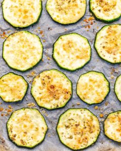 Fried zucchini slices on a baking sheet.