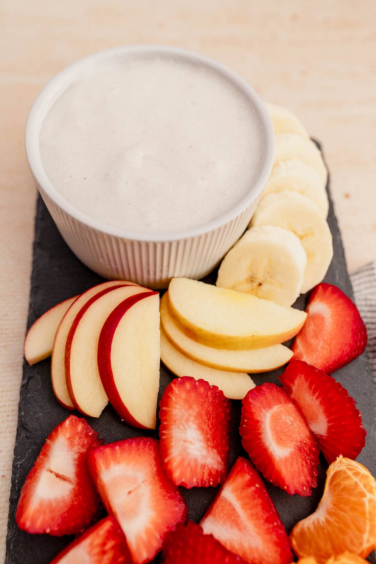 A bowl of delicious fruit dip with fresh strawberries and bananas.