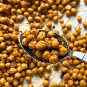 A spoon full of roasted chickpeas.