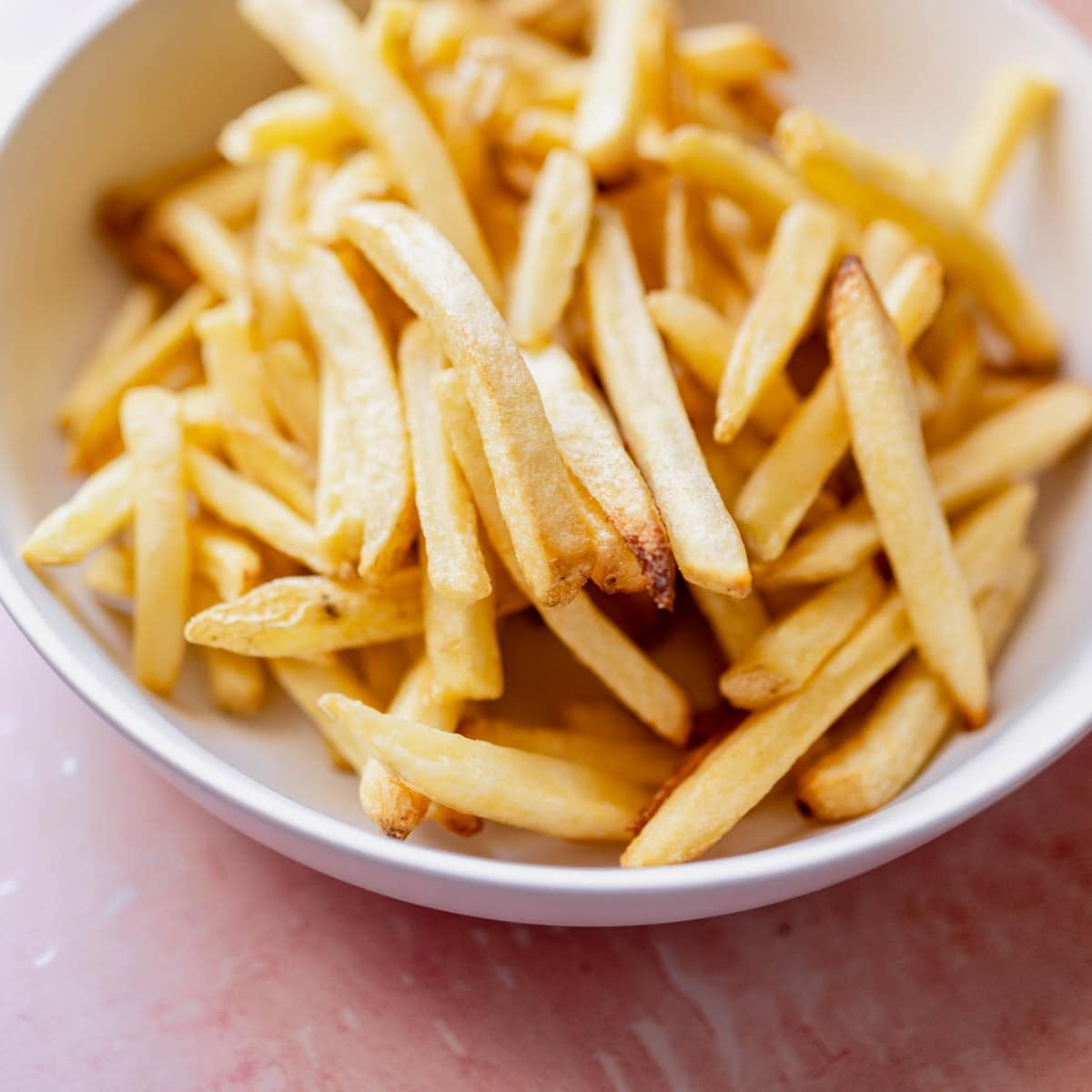 A bowl of golden, air fryer frozen french fries.