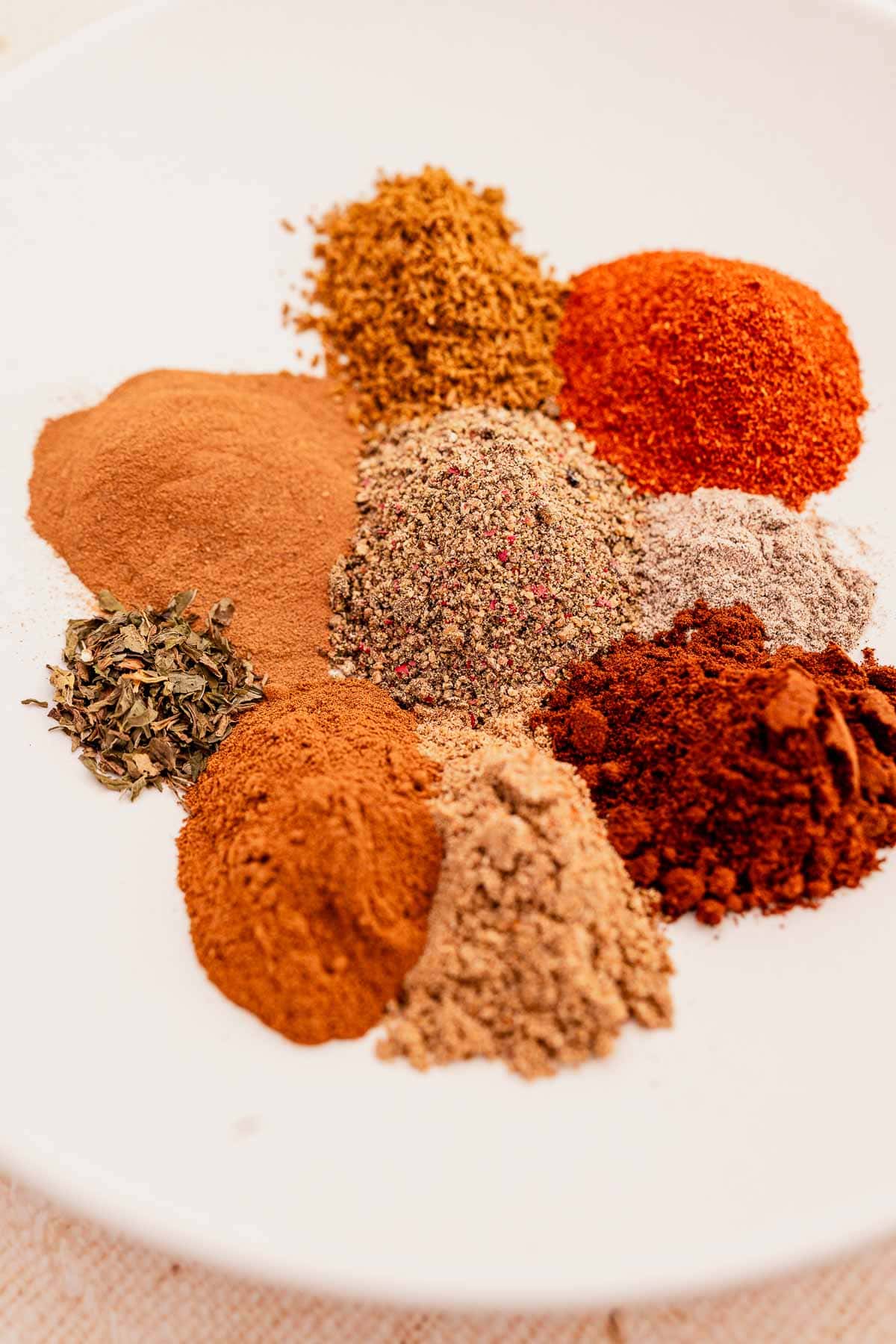 Baharat spices on a white plate.