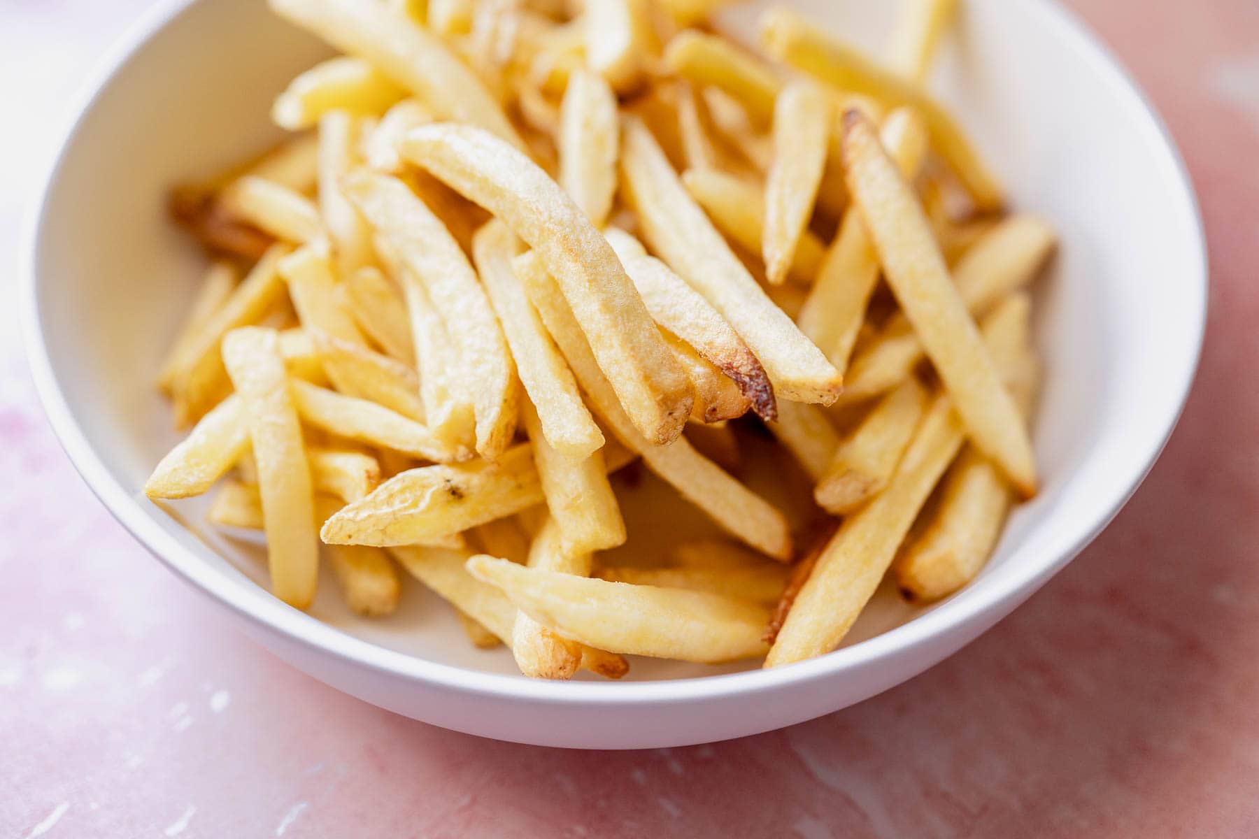 A bowl of freshly cooked air fryer french fries.