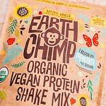 A decorative package of high protein Earth Chimp vegan protein shake mix with illustrations of sunflowers, leaves, and butterflies on a textured background.