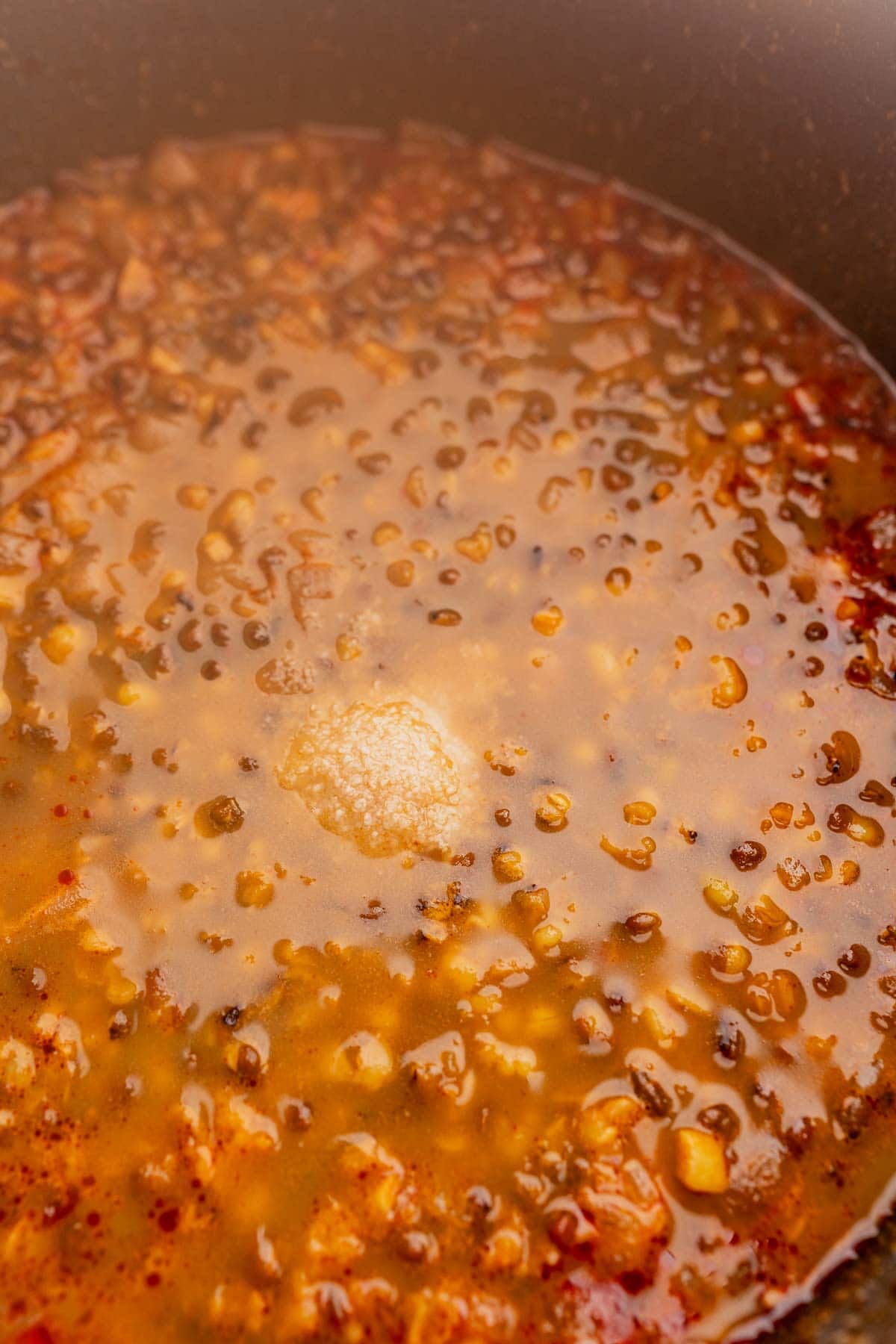 Cooked mung bean soup in a pot sprinkled with salt.