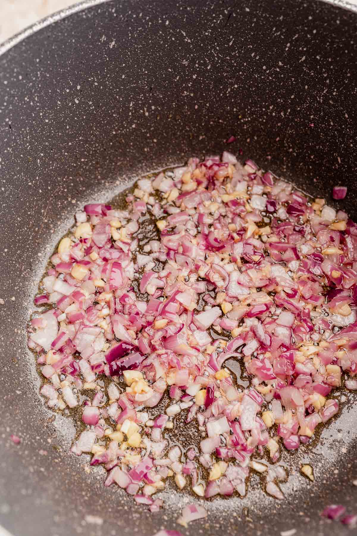 Softened onions in a pot.