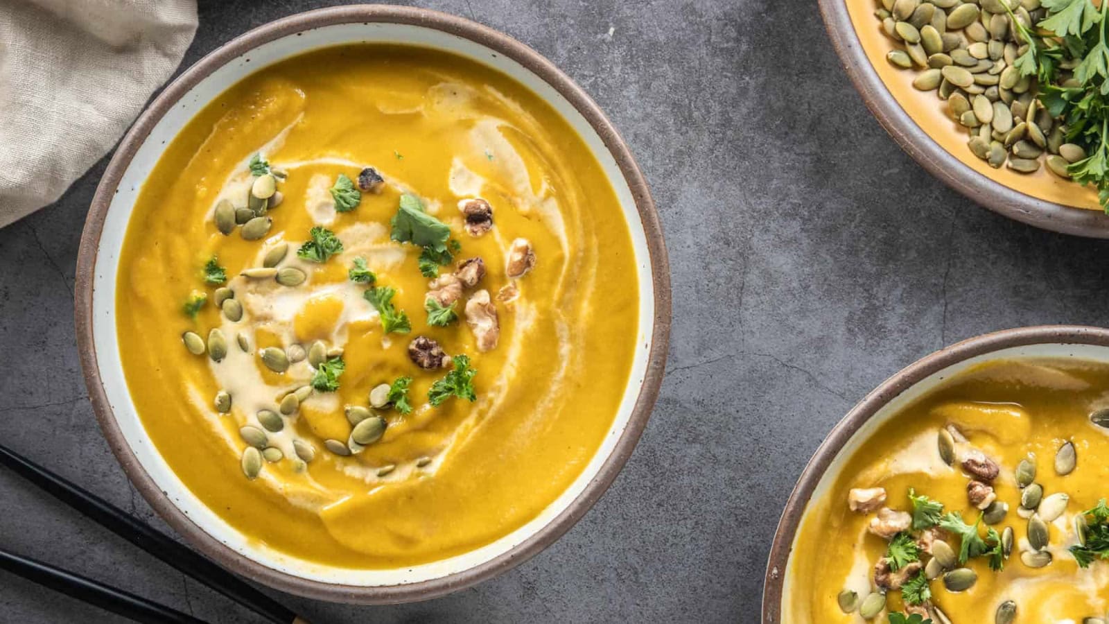 An overhead image of spicy pumpkin soup served in a bowl.