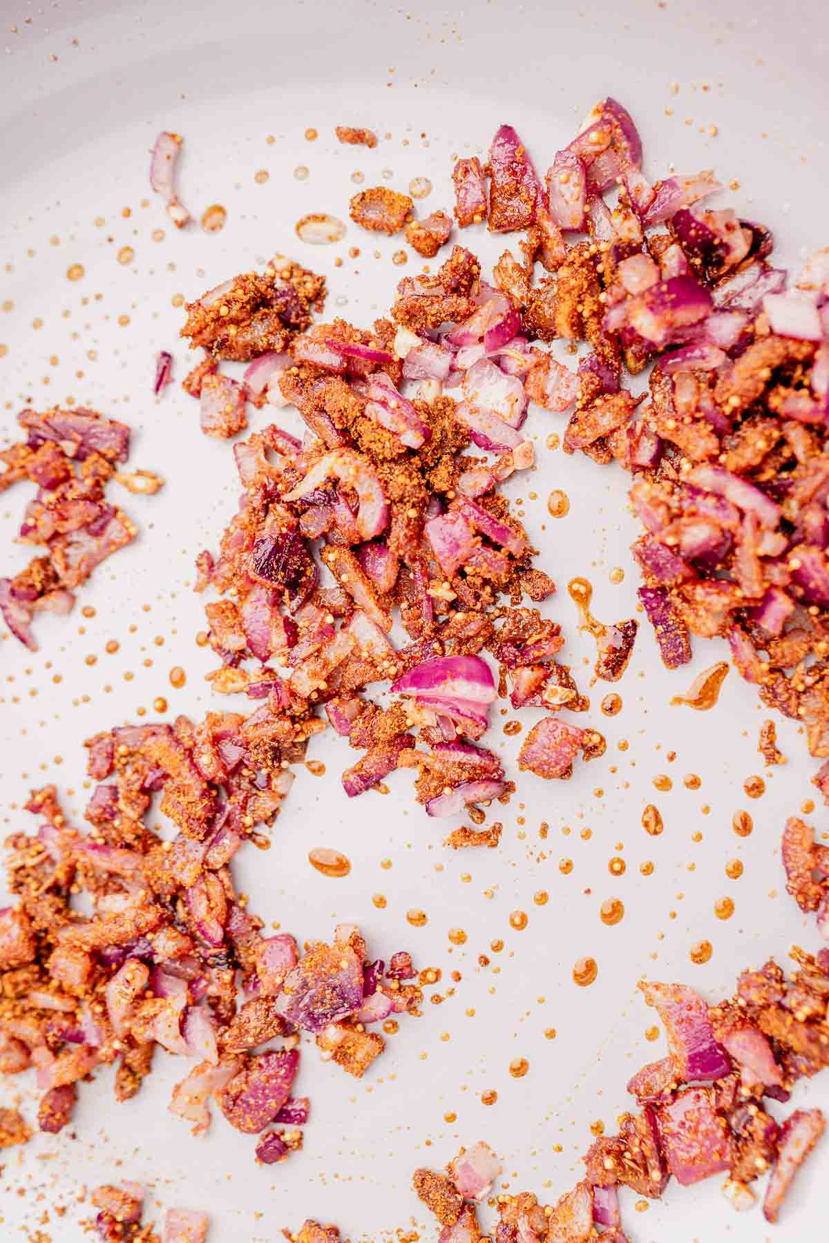 Sauteed spices and onions cooking in a pot.