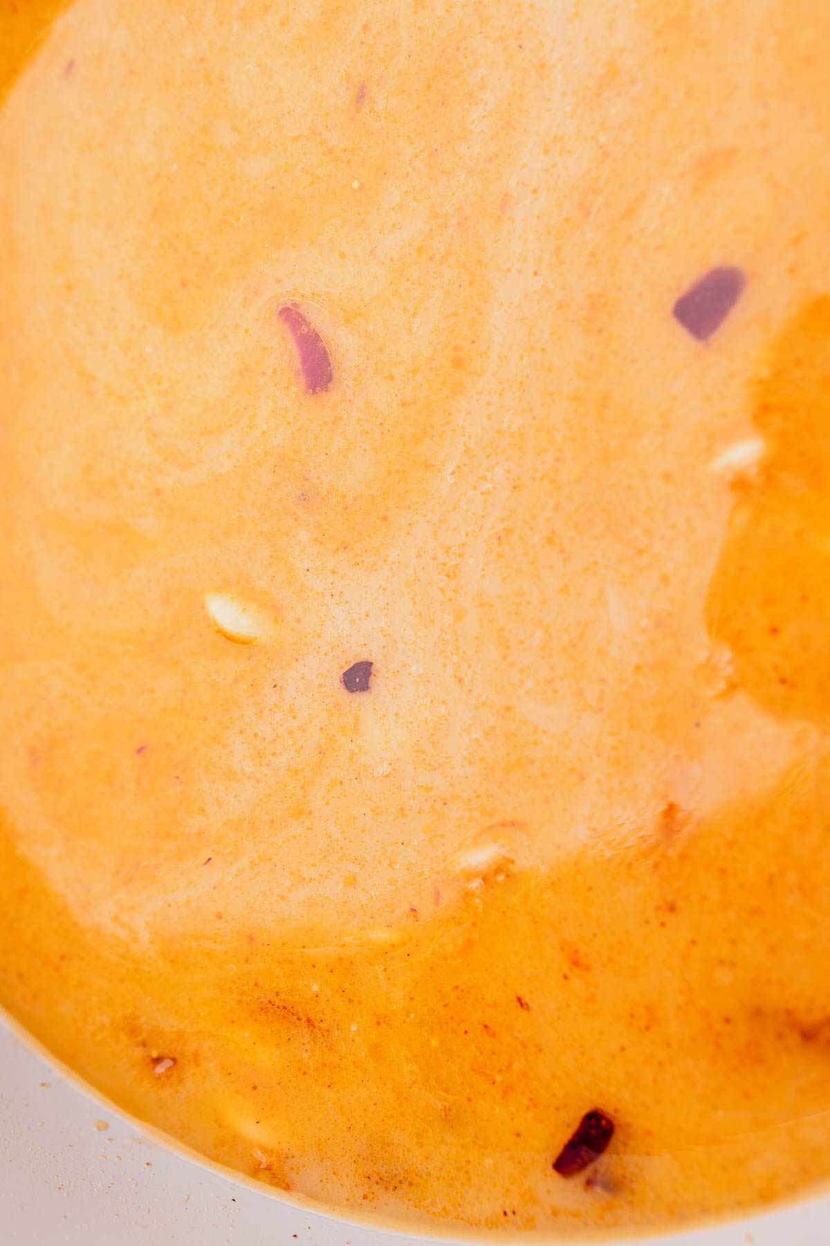 Butter bean curry being brought to a simmer.