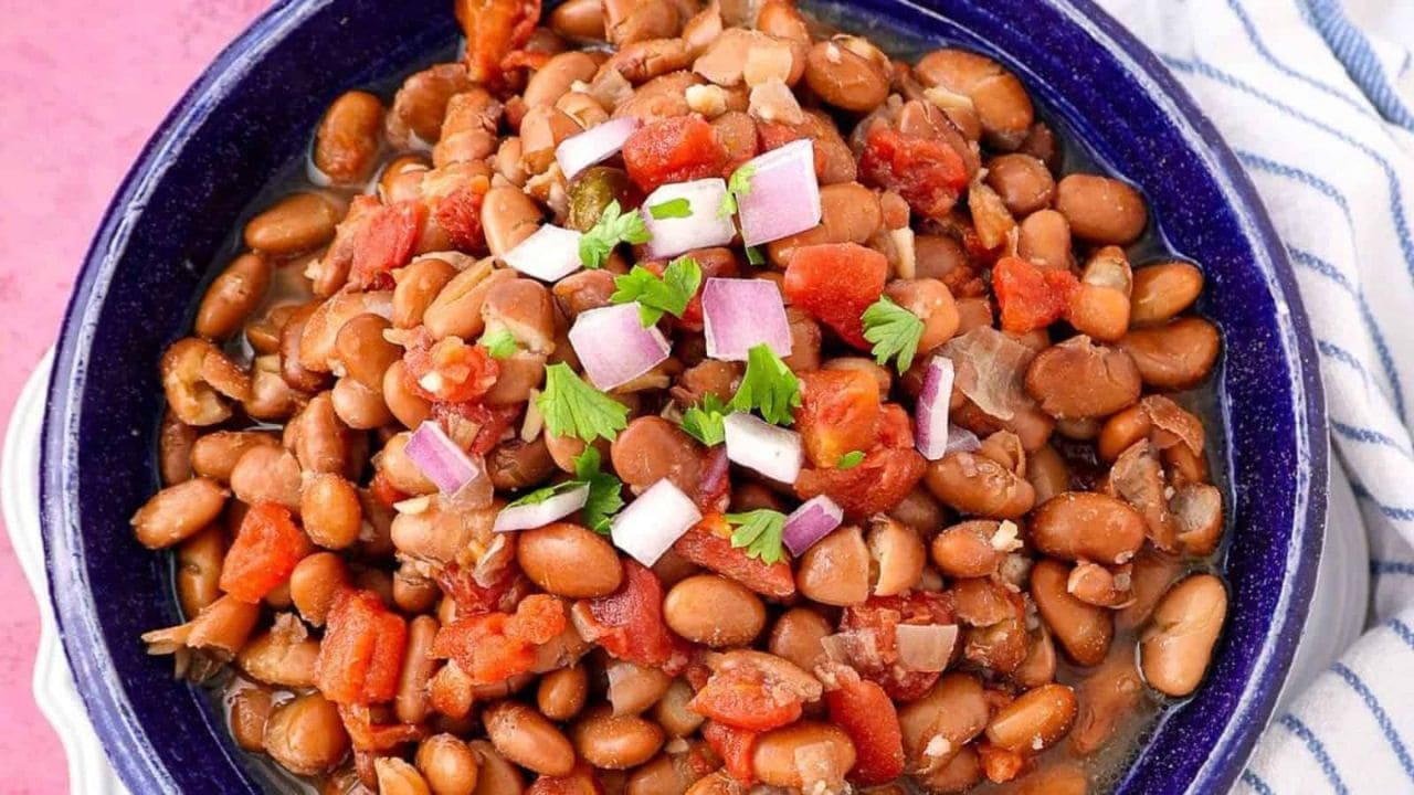 A bowl of crock pot pinto beans with a rich, hearty texture.