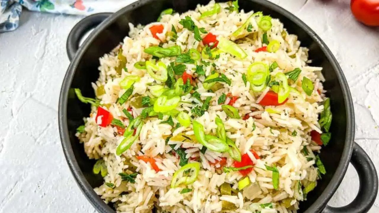 Mediterranean Rice in a black bowl on concrete.