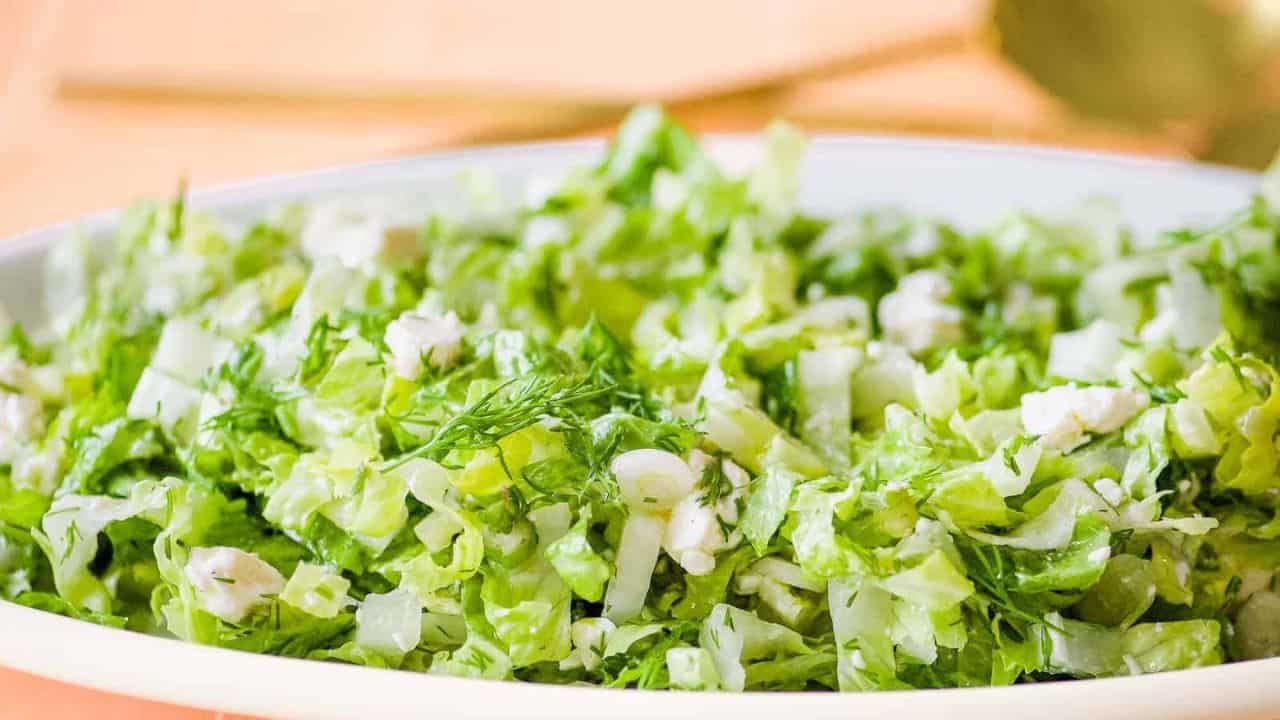 Closeup side view shot of Prasini salad in a white dish.