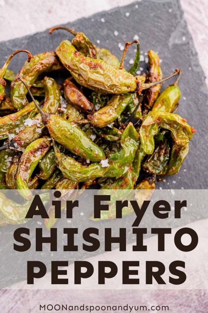 A plate of air fryer shishito peppers on a slate surface, sprinkled with salt. Text at the bottom: "Air Fryer Shishito Peppers.