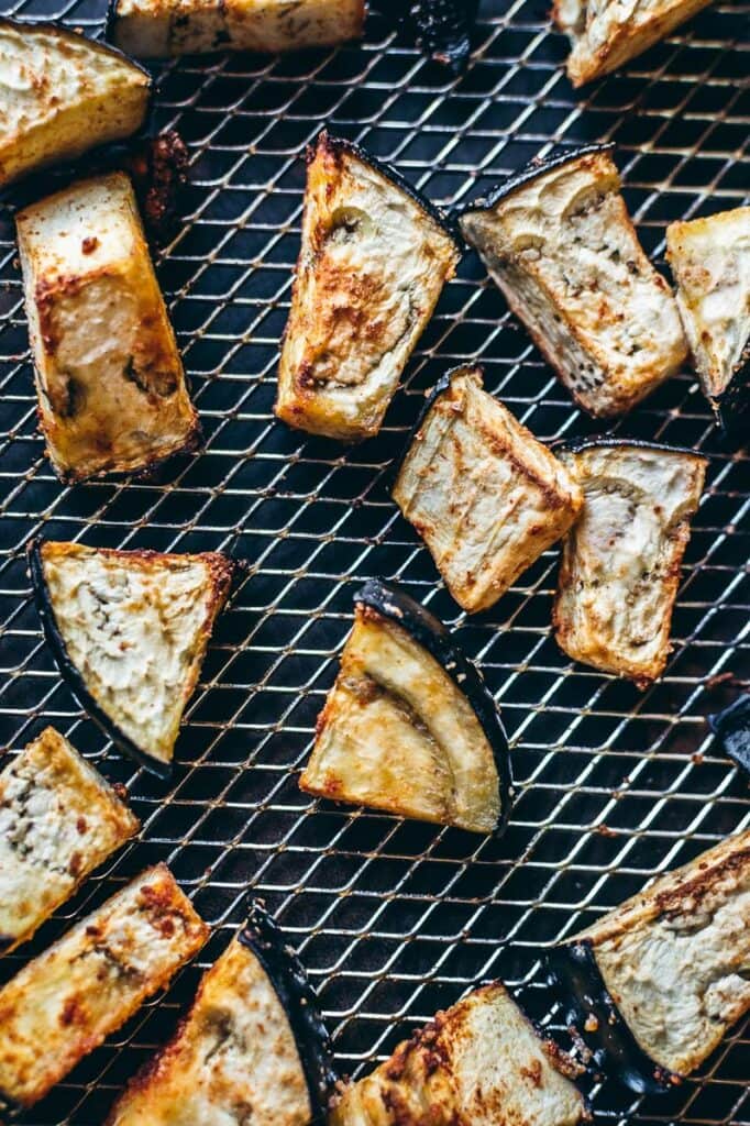 Chunks of roasted eggplant, perfectly tender, rest on a wire rack after their quick transformation in the air fryer.