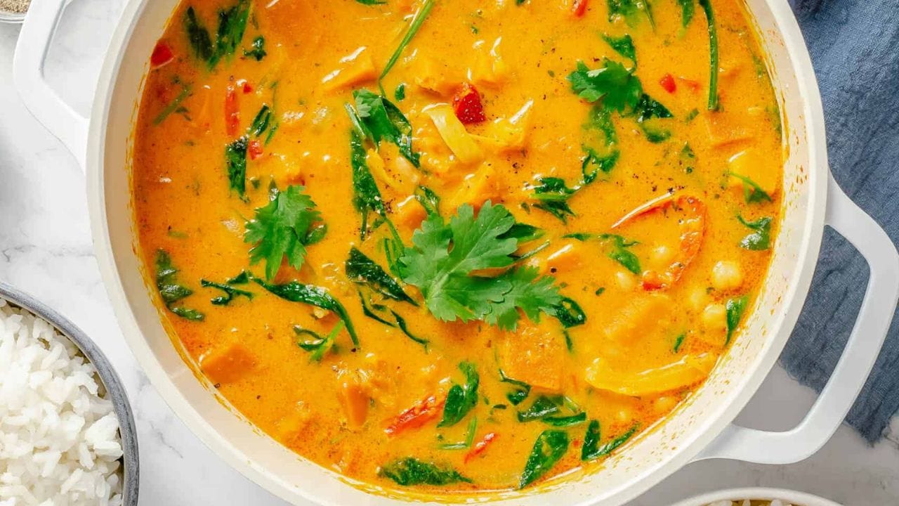 Overhead shot of a white pot with Thai pumplkin curry.