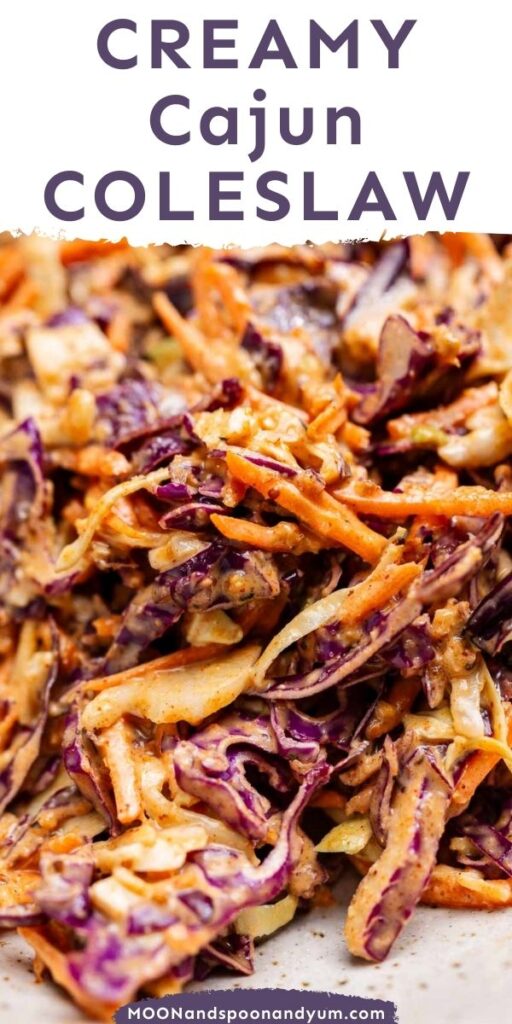 Close-up of creamy Cajun coleslaw with shredded purple and green cabbage, carrots, and a spicy dressing.