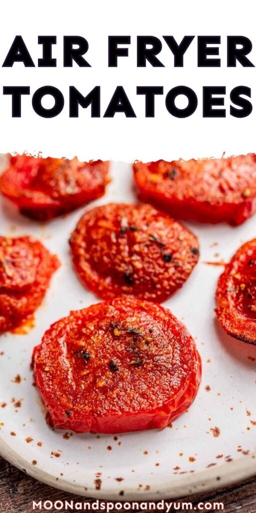 Close-up of sliced, seasoned tomatoes cooked in an air fryer, arranged on a white plate.