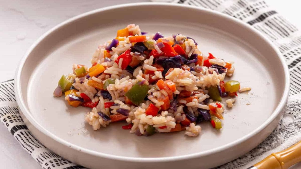 An overhead image of Nigerian fried rice in a serving bowl.