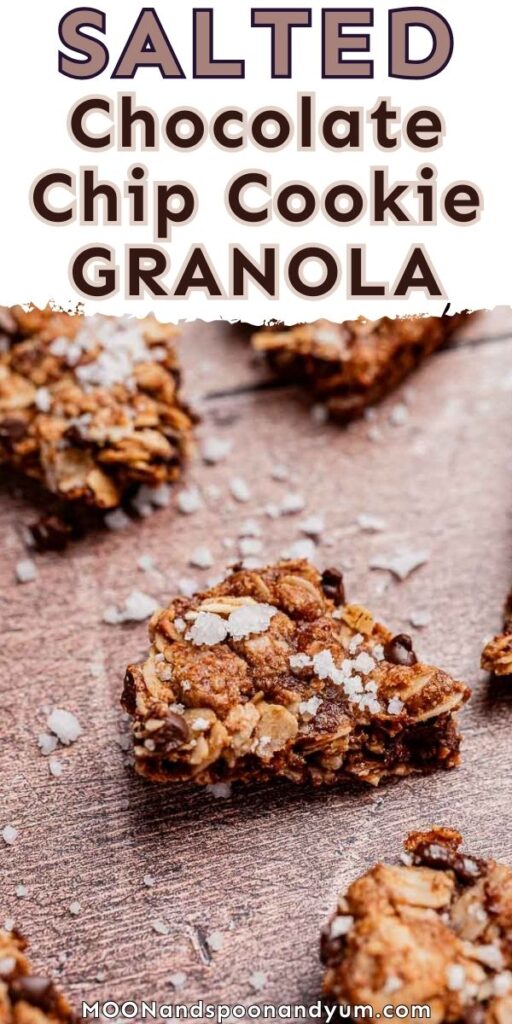 Close-up of chocolate chip cookie granola pieces on a wooden surface, sprinkled with coarse salt for a tempting sweet and salty finish.