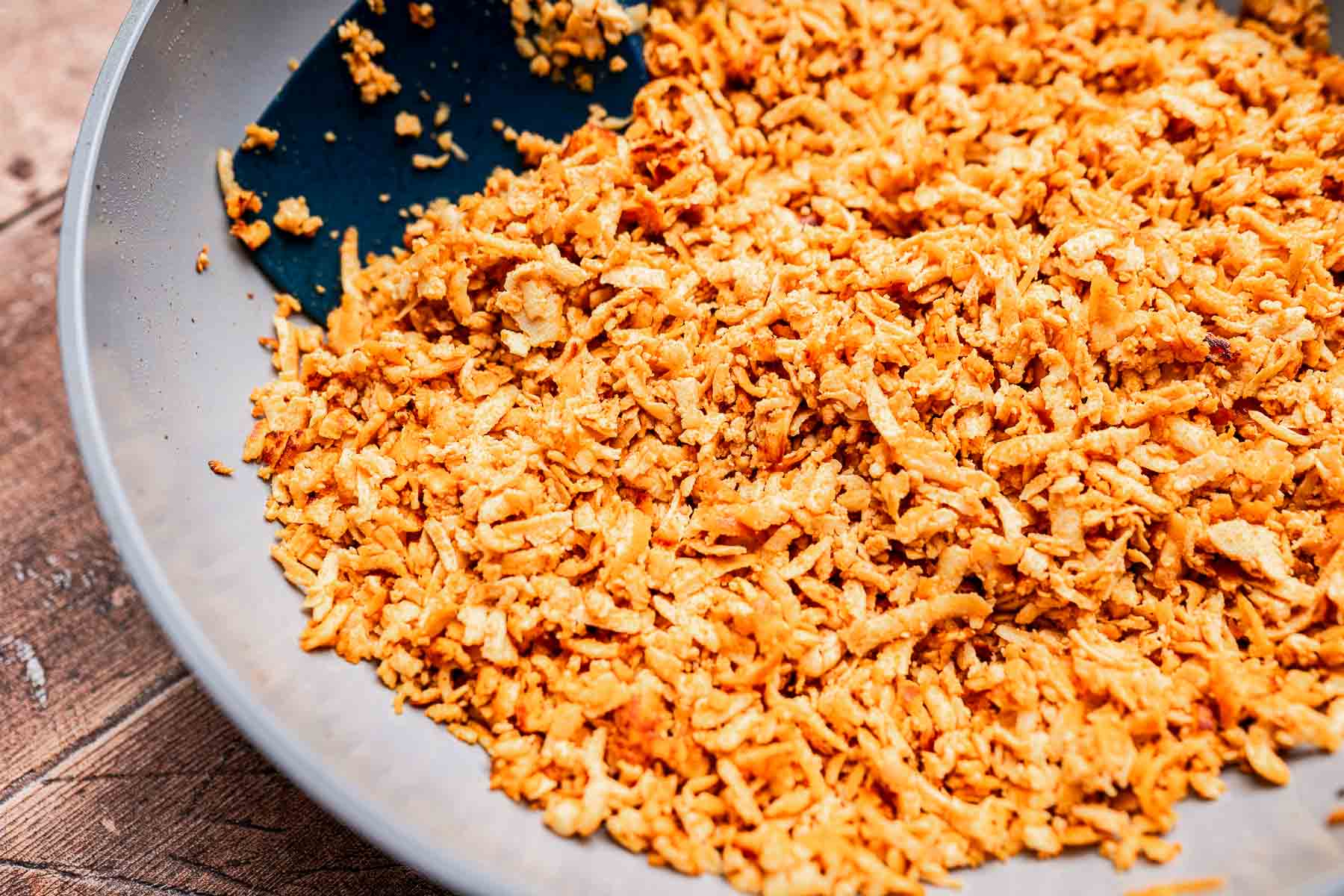 Savory fried onions in a pan, perfect for adding to your tofu tacos.