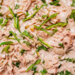 Shredded jackfruit in a creamy ginataang langka sauce, garnished with sliced green peppers, chopped onions, and fresh cilantro.