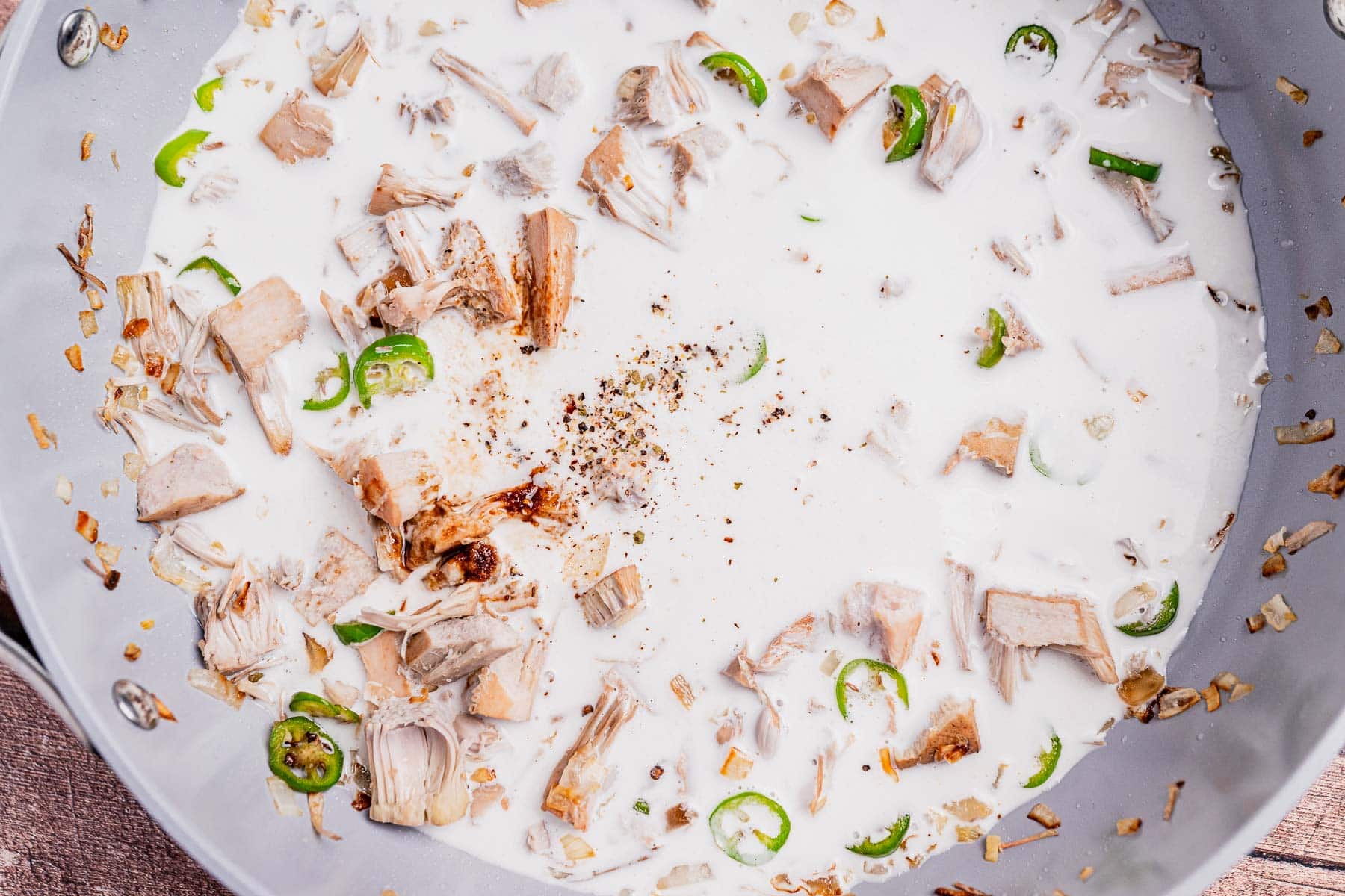 Chunks of jackfruit, sliced green chilies, onions, and black pepper simmer in coconut milk for a classic ginataang langka.