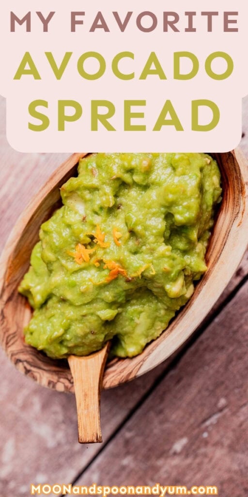 A wooden bowl with a wooden spoon filled with creamy avocado spread; text above reads “My Favorite Avocado Spread.”.