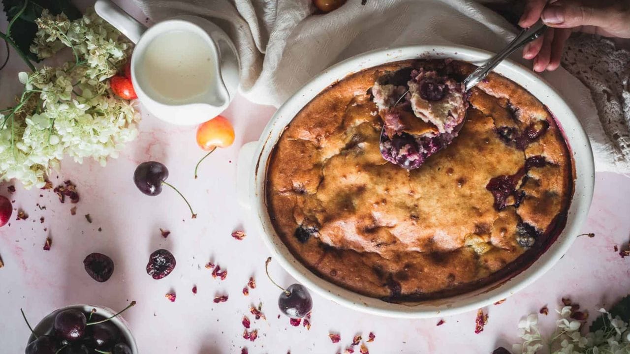 side view of slice of cherry cobbler with ice cream.