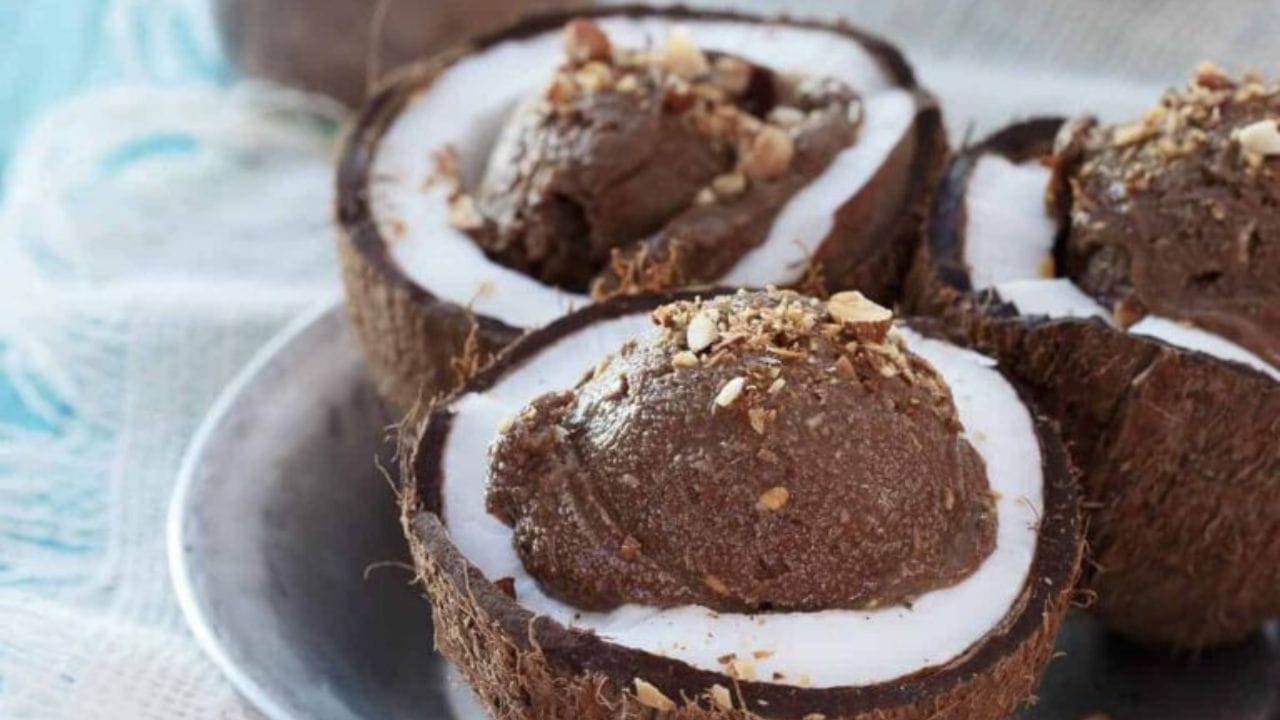 Chocolate coconut avocado ice cream in coconut shells.