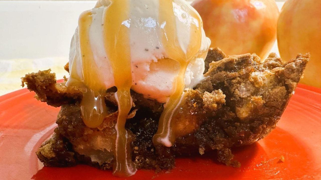 A piece of apple bar with ice cream and caramel sauce.