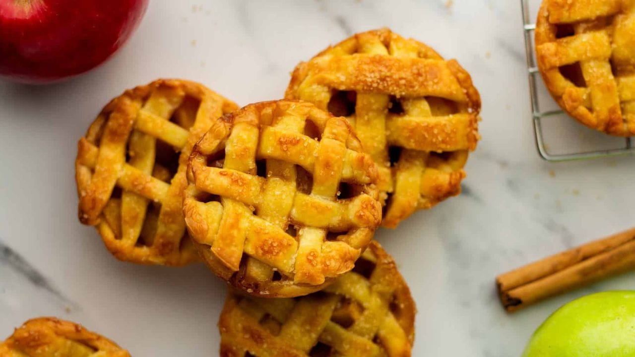 An overhead image of a stack of mini apple pies.