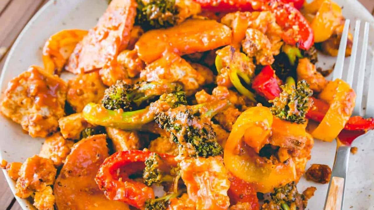 Sheet pan tofu and vegetables with BBQ sauce on a plate.