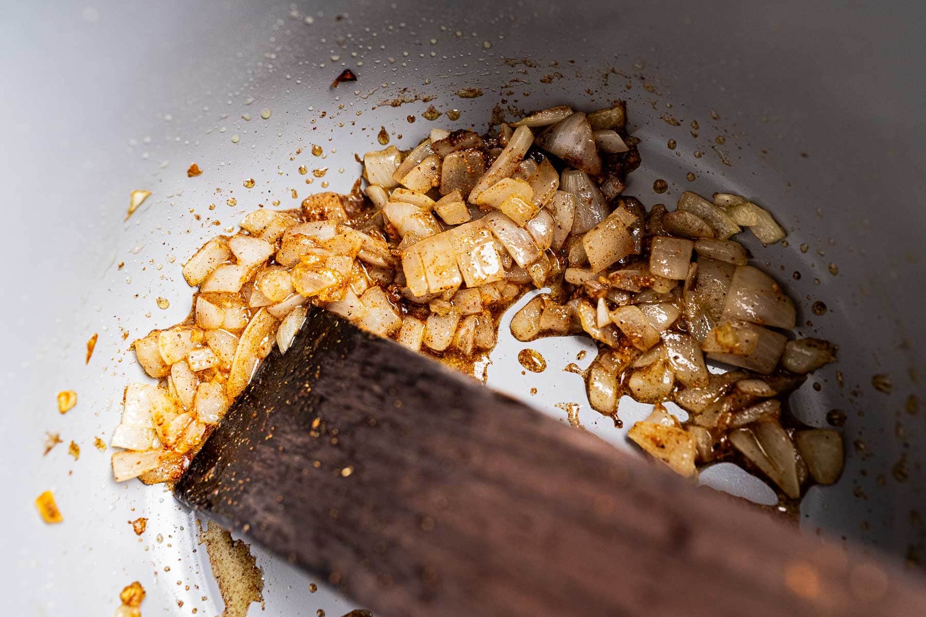 Sauteed onion with spices in a pot.