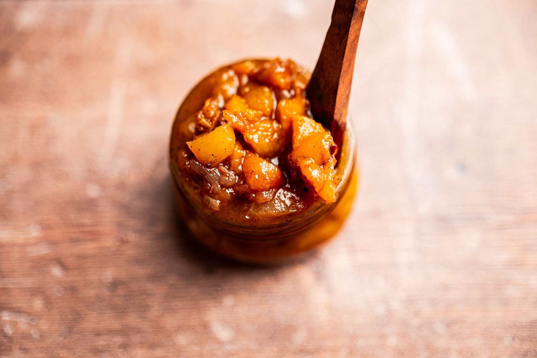 Homemade peach chutney with visible peach pieces and spices.