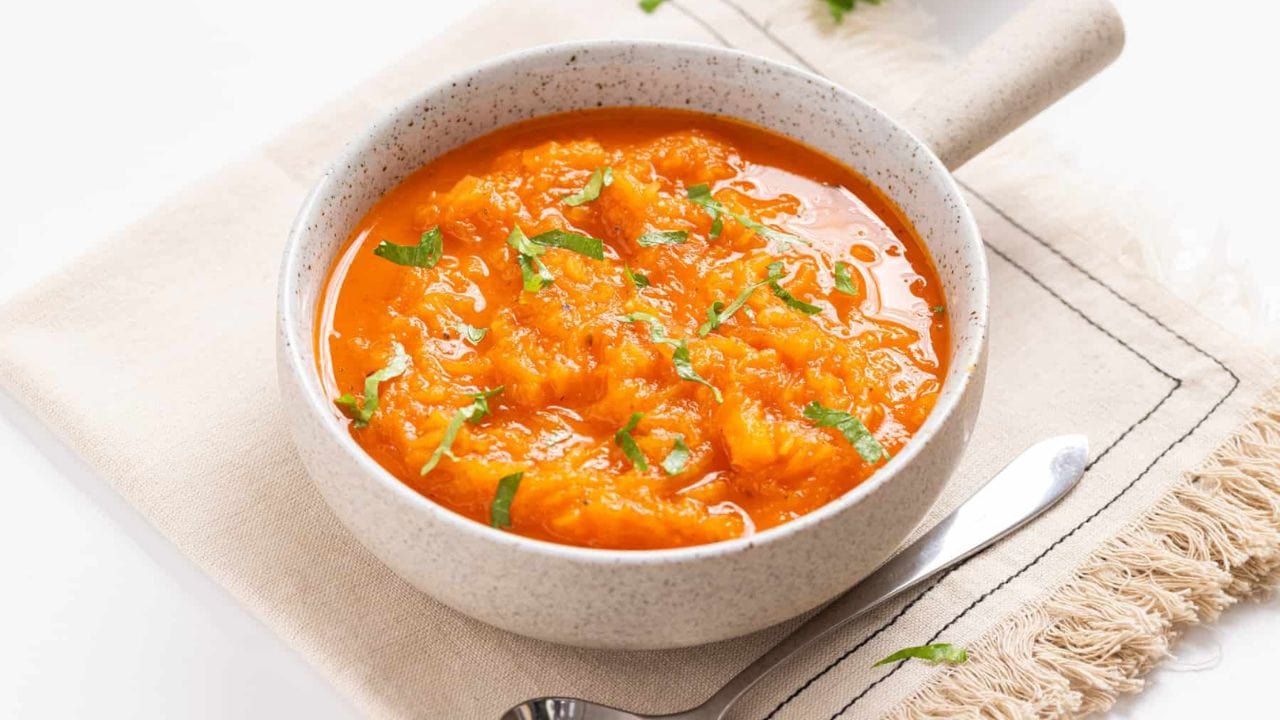 Close up of spaghetti squash soup in a white bowl.