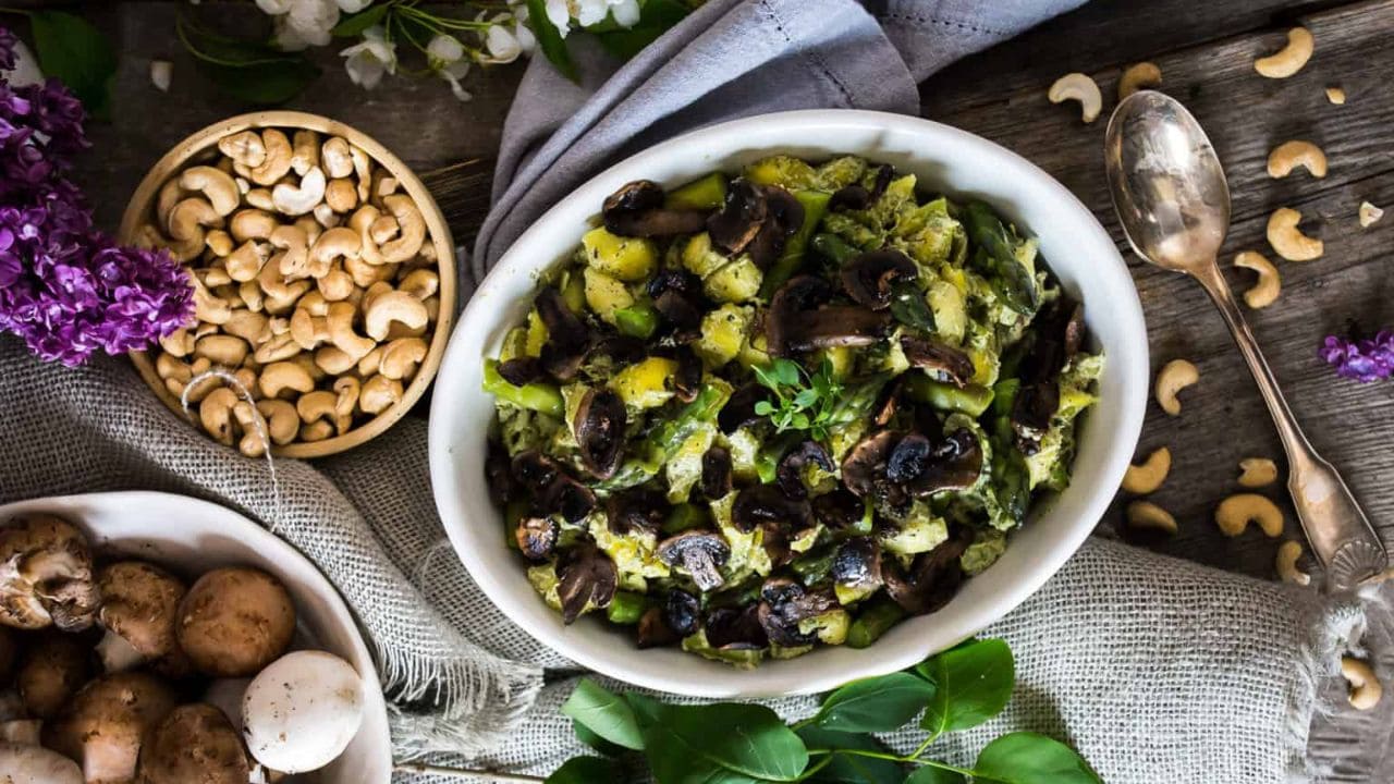 Overhead of pasta with mushrooms and green goddess sauce.