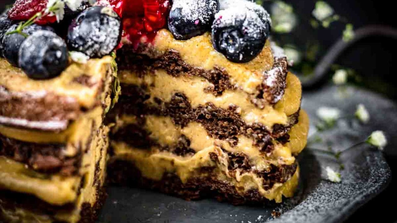 Chocolate Chaffle Cake on a plate with whole cake in the background.
