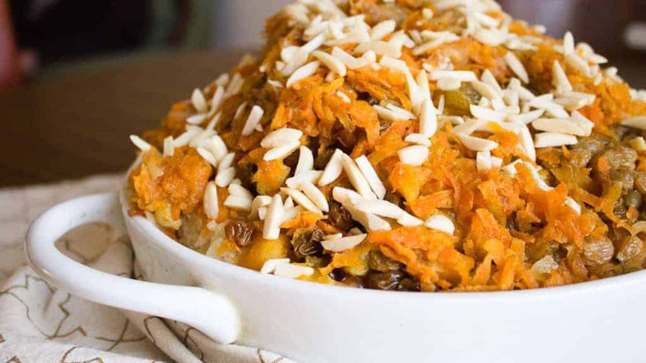 Jeweled vegetarian rice plov topped with shredded carrots, golden raisins, lentils and slivered almonds.
