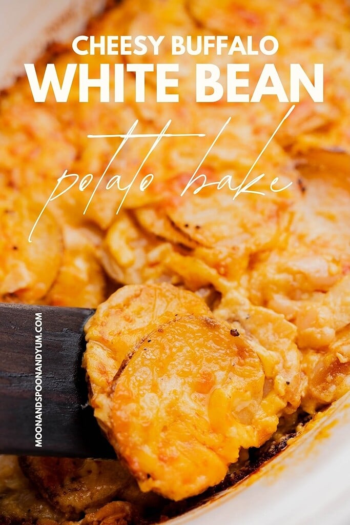 Close-up of a cheesy buffalo potato casserole, with white beans and potatoes, as a hearty serving is lifted from the dish.