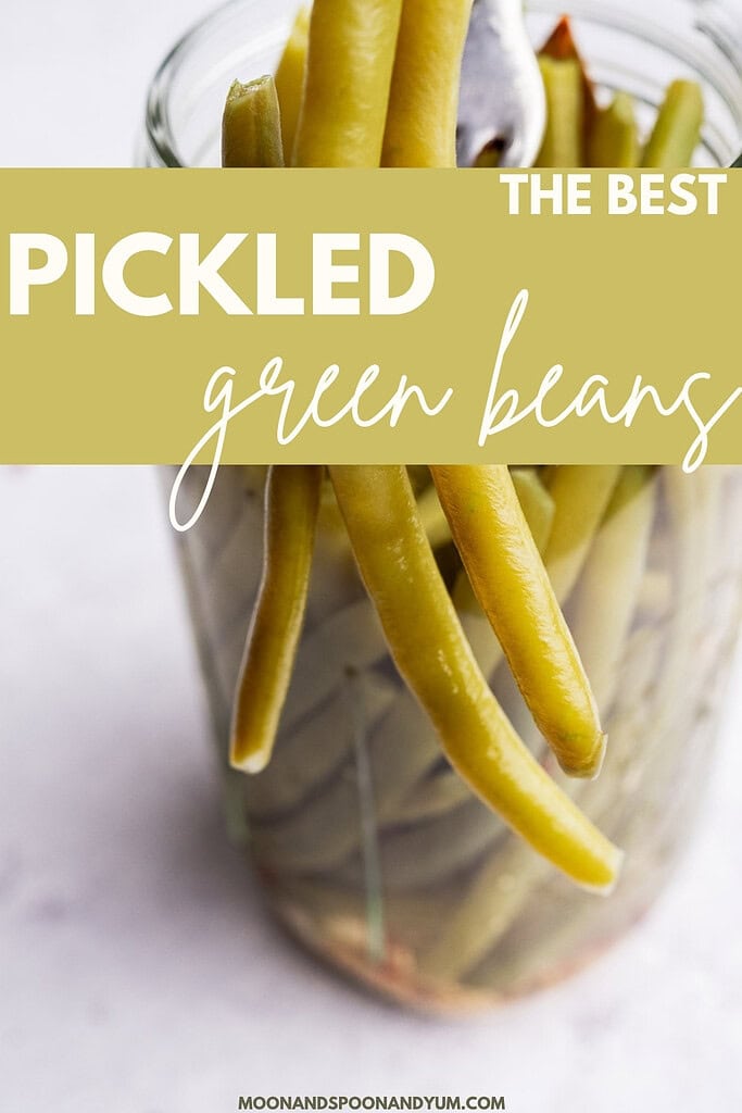 A glass jar filled with pickled green beans, featuring a text overlay that reads "The Best Pickled Green Beans." Perfect for anyone craving crisp and tangy pickled green beans.