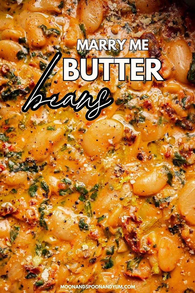 Close-up of creamy marry me butter beans with spinach, sun-dried tomatoes, and herbs in a rich sauce. Text overlay reads “Marry Me Butter Beans.”.