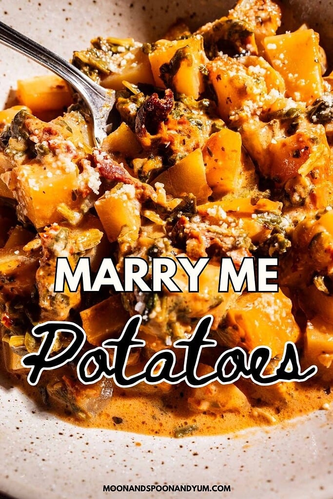 A bowl of creamy, seasoned marry me potatoes with herbs and spices, topped with grated cheese. Text overlay reads "MARRY ME Potatoes.