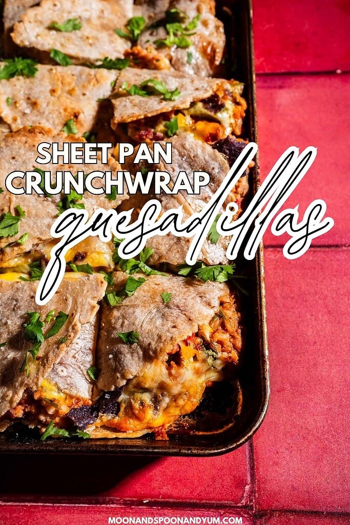 A sheet pan filled with baked sheet pan crunchwrap quesadillas, cut into squares and topped with chopped parsley, sits on a red surface. Text overlay reads, "Sheet Pan Crunchwrap Quesadillas.